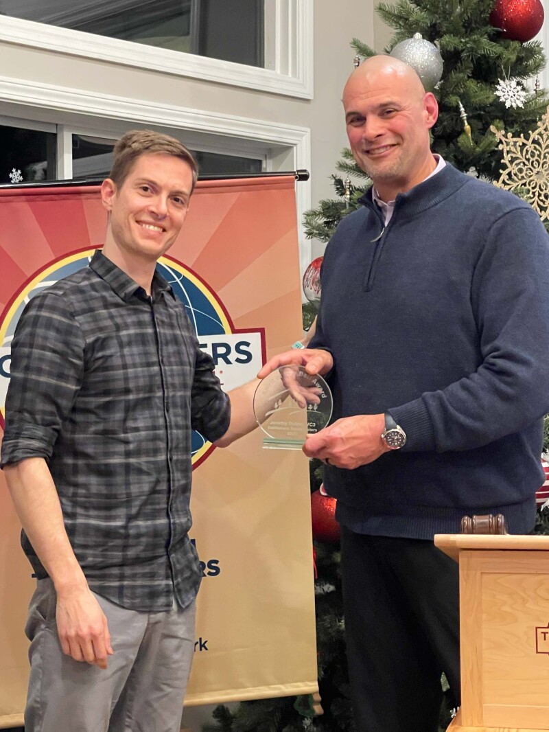 Jeremy Dubay accepting 2023 Ray Bell Award from Ben Biskynis