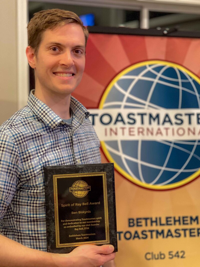 Ben Biskynis displaying  his 2024 Ray Bell award for service to Bethlehem Toastmasters